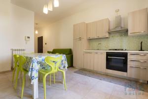- une cuisine avec une table et des chaises dans la chambre dans l'établissement Appartamento Fontana Greca 4 ,Gallipoli, à Gallipoli