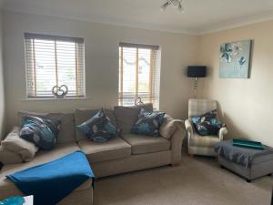 a living room with a couch and a chair at Eaton Ford Green Apartment in Saint Neots