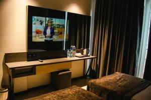 a desk in a hotel room with a mirror at Peramis Hotel & Spa in Antalya