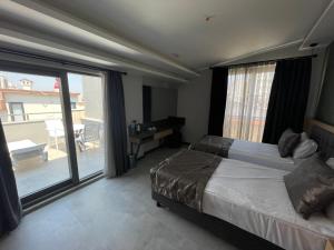a bedroom with a bed and a large window at Peramis Hotel & Spa in Antalya