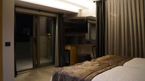 a bedroom with a bed and a sliding glass door at Peramis Hotel & Spa in Antalya