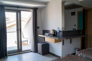 a room with a counter with a mirror and a window at Peramis Hotel & Spa in Antalya