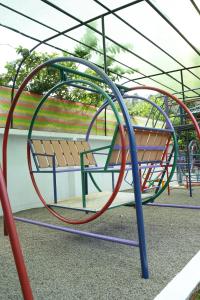 a playground with a bench in a park at Agasthya Private Pool & Park villa in Sultan Bathery