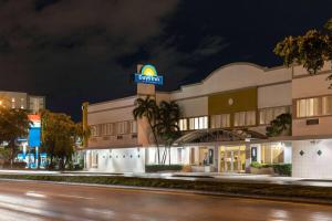 a hotel with a sign on the side of a street at Days Inn by Wyndham Miami Airport North in Miami