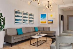 a living room with a couch and a table at Days Inn by Wyndham Miami Airport North in Miami