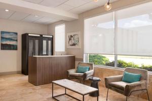 a waiting room with two chairs and a counter at Days Inn by Wyndham Miami Airport North in Miami