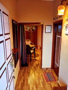 a hallway with a door open to a room with a table at Traveller Hive Kasar Devi in Almora