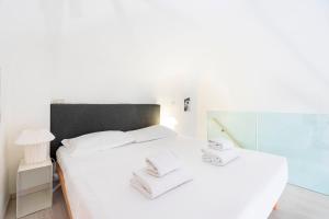 a bedroom with a bed with white sheets and a mirror at Venezia Double in Florence
