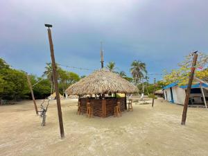 a hut with a straw roof on a beach at El Cocotal Tintipán By Ashram in Tintipan Island