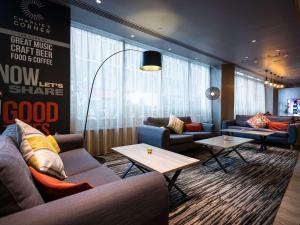 a lobby with couches and tables in a room at ibis London City - Shoreditch in London