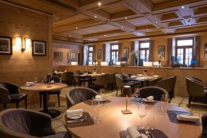 ツェルマットにあるモンセルヴァン パレスのテーブルと椅子が備わるレストラン