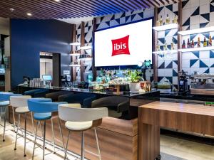 a restaurant with a bar with a tv on the wall at ibis Lima Larco Miraflores in Lima