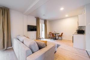 a living room with a couch and a table at Studio Haarajoki in Järvenpää