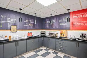 a kitchen with gray cabinets and a checkered floor at Hampton Inn Cleveland-Westlake in Westlake