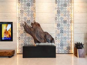 a statue of a tree on a table in a room at Mercure Singapore Bugis in Singapore