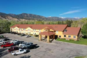 an aerial view of a hotel with cars parked in a parking lot at Baymont by Wyndham Salida in Salida