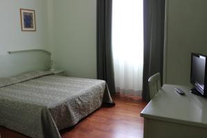 Postel nebo postele na pokoji v ubytování Hotel Altieri