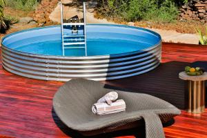 a small pool with a chair and a towel on a table at Battle Creek Safaris in Derby