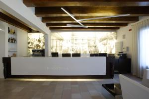 a large white reception desk in a room at Vico Regio Hotel in Casarano