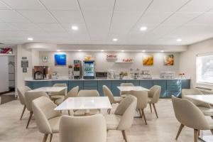 a restaurant with tables and chairs and a counter at Comfort Inn & Suites Louisville Airport Fair & Expo in Louisville