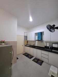 a kitchen with white cabinets and a stainless steel refrigerator at Andra Homestay KLIA,13 mins to KLIA ,Self Check-in,Free WiFi & Parking,Family Friendly in Sepang +13 photos