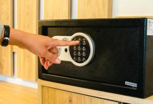 a person pointing at a microwave with their hand on it at Peramis Hotel & Spa in Antalya