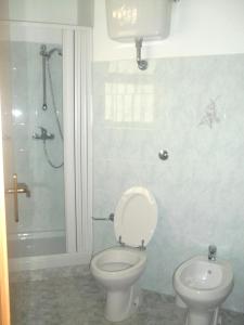a bathroom with a toilet and a shower at Hotel Celestina in Villapiana