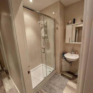a bathroom with a shower and a sink at Crossways Cottage Quirky 2 bedroom cottage in Central location in Peebles
