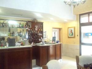 a bar in a restaurant with a counter at Hotel Celestina in Villapiana
