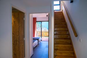 a hallway with a stairway leading to a living room at Pure Montagne Resort & Spa in Saint-Martin-Vésubie