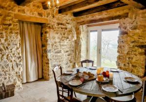a wooden table in a room with a window at Chateau d'Impasse in Laferté-sur-Amance