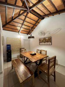 a dining room with a wooden table and chairs at Hut in the sky in Bangalore