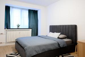 Säng eller sängar i ett rum på Apartament Dorobanti