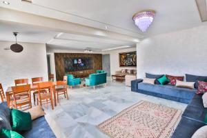 a living room with a blue couch and a dining room at Luxury Apartment Fez in Fès