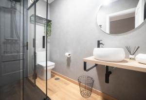 a bathroom with a sink and a mirror at Apartamento AN Sol “Ferrol” in Ferrol