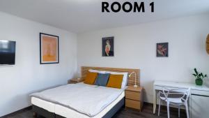 a small bedroom with a bed and a desk at Bookhouse apartment by Prague Castle in Prague