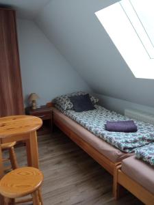 a small bedroom with a bed and a table at Farcik Apartament in Nowa Wieś