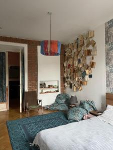 a bedroom with a bed and a wall with books at kushki's home in Tbilisi City