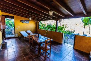 a dining room with a wooden table and chairs at Casa Tajonaje - Entorno rural in Alajeró