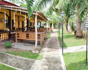 a restaurant with wooden tables and a street light at Edsan Apartment in Bantayan Island