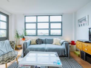 a living room with a couch and a coffee table at Pass the Keys Central Location Flat near Old St and Dalston Overlooking Rosemary Park and Regents Canal in London