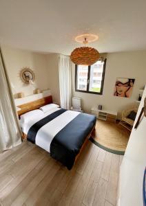 a bedroom with a large bed and a window at Splendid house, Jacuzzi and Private Gardens Paris in Boulogne-Billancourt