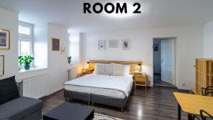 a hotel room with a bed and a couch at Bookhouse apartment by Prague Castle in Prague