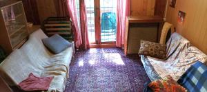 a living room with a couch and a window at Old cottage, steep hill, read info and rating in Rozdrojovice +57 photos