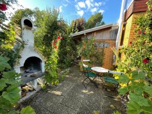 a patio with a fireplace and a table and chairs at Ferienhaus Marienleuchte in Marienleuchte