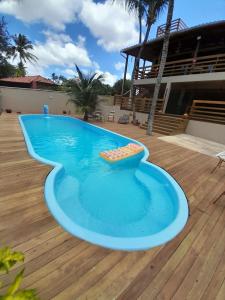 a swimming pool in the middle of a wooden deck at Casa Sol do Gostoso in São Miguel do Gostoso