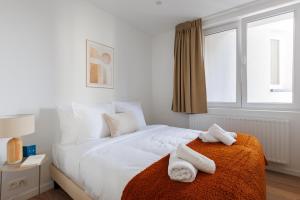 a bedroom with a bed with two towels on it at Sweett - Bodeghem in Brussels