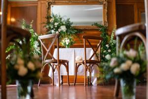 a table with two chairs and a table with flowers at The Grosvenor Stockbridge in Stockbridge