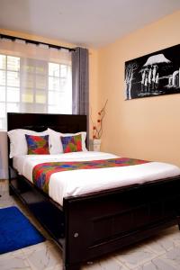 a bedroom with a large bed in a room at Rozie Apartment in Kisumu