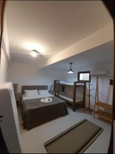 a bedroom with a bed and a desk in it at Casa Sol do Gostoso in São Miguel do Gostoso